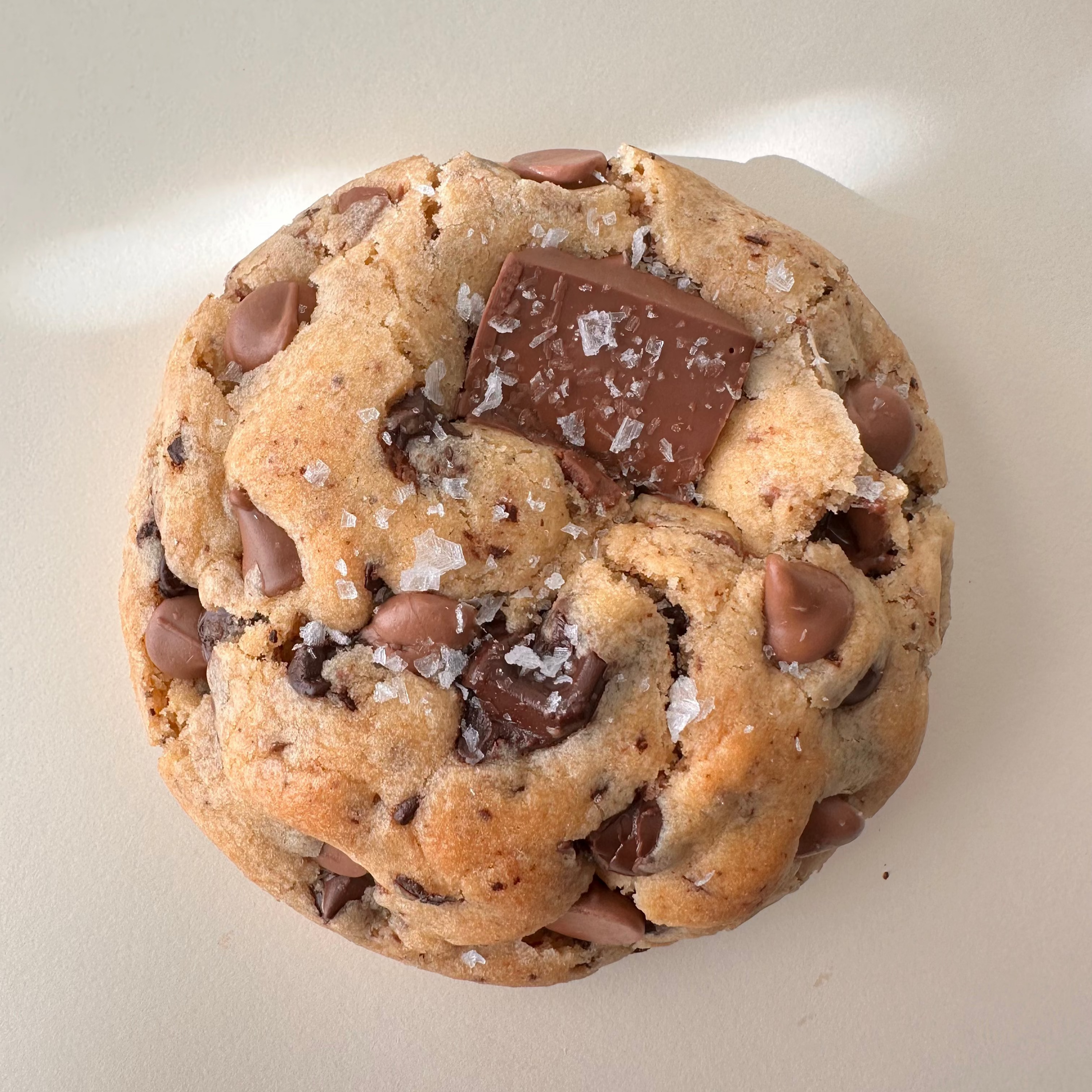 Chocolate chip cookie on a white surface